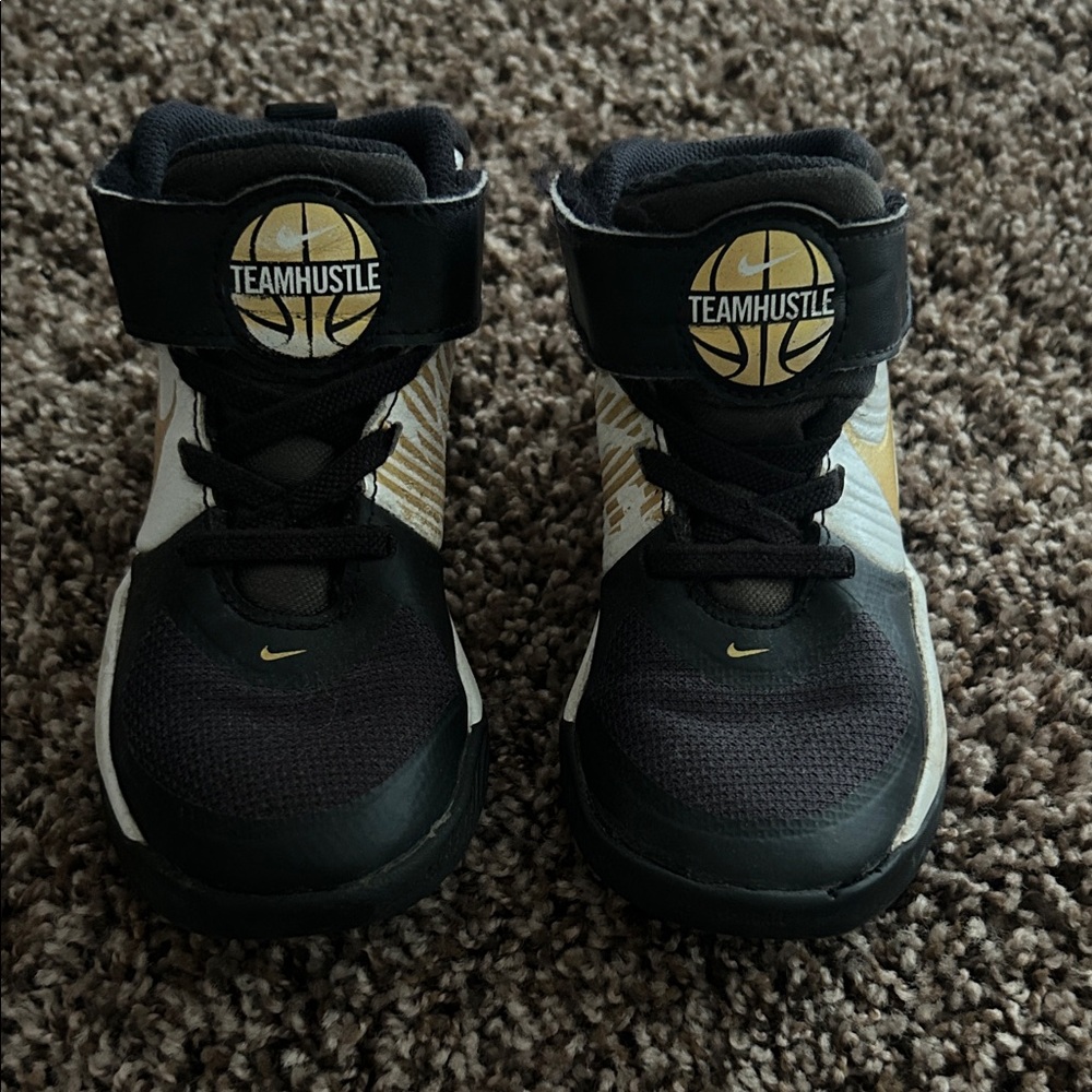 Nike Team Hustle Kids Sneakers - Black, White, and Gold